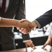 A businessperson and a customer shaking hands