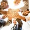 A successful testing team in a circle with their hands in the middle