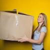 Smiling woman holding a large box, photo by bruce mars