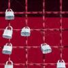 Locks on a red fence, photo by Jon Moore