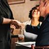 Woman shaking hands with a job candidate after a hiring interview