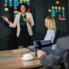 A woman smiling while giving a great presentation