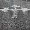 Asphalt with painted arrows pointing in three directions