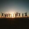 Silhouette of team members jumping up to cheer